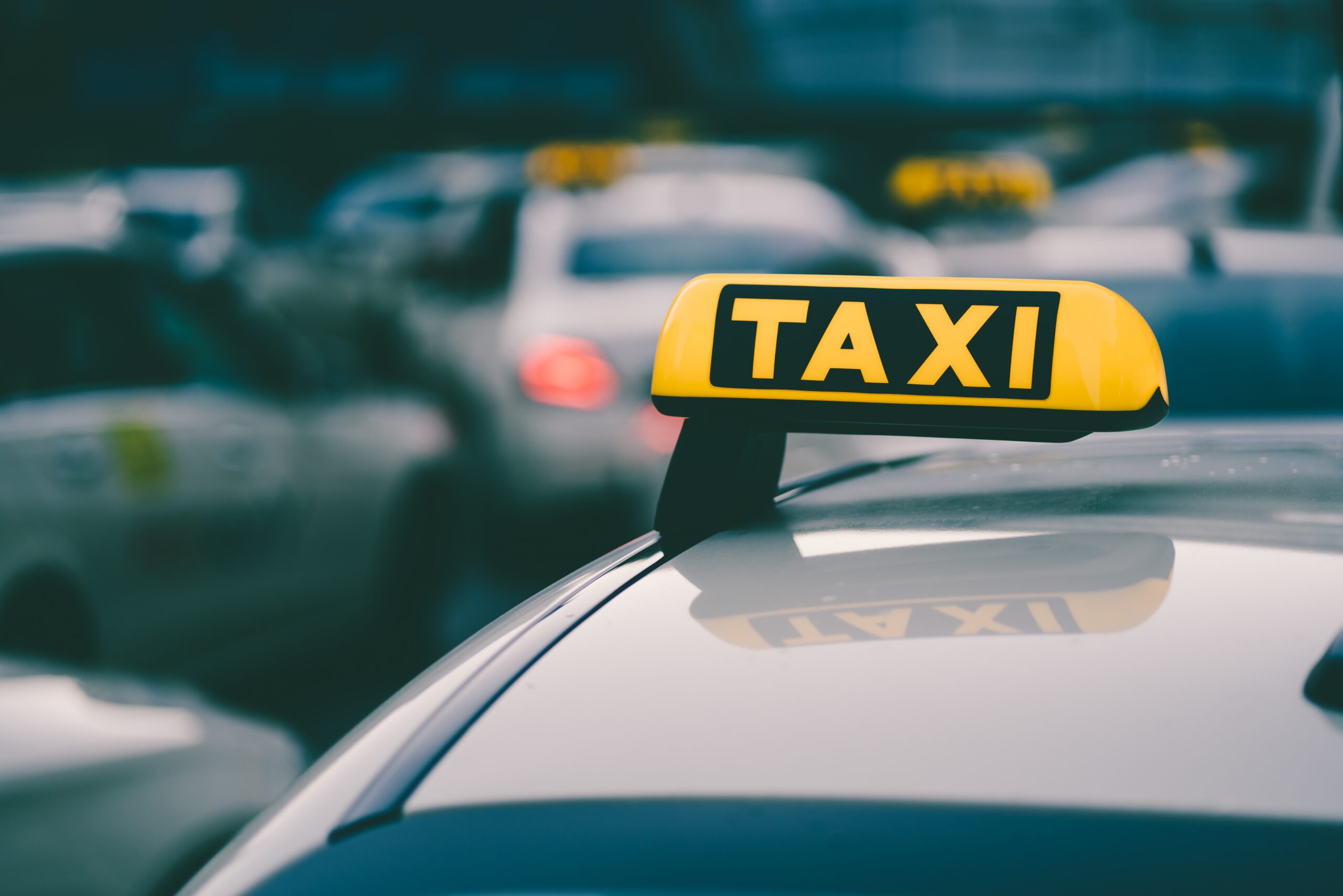 selective focus shot yellow taxi sign traffic jam scaled